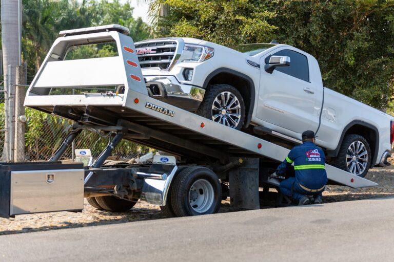 tow truck driver loading a vehicle